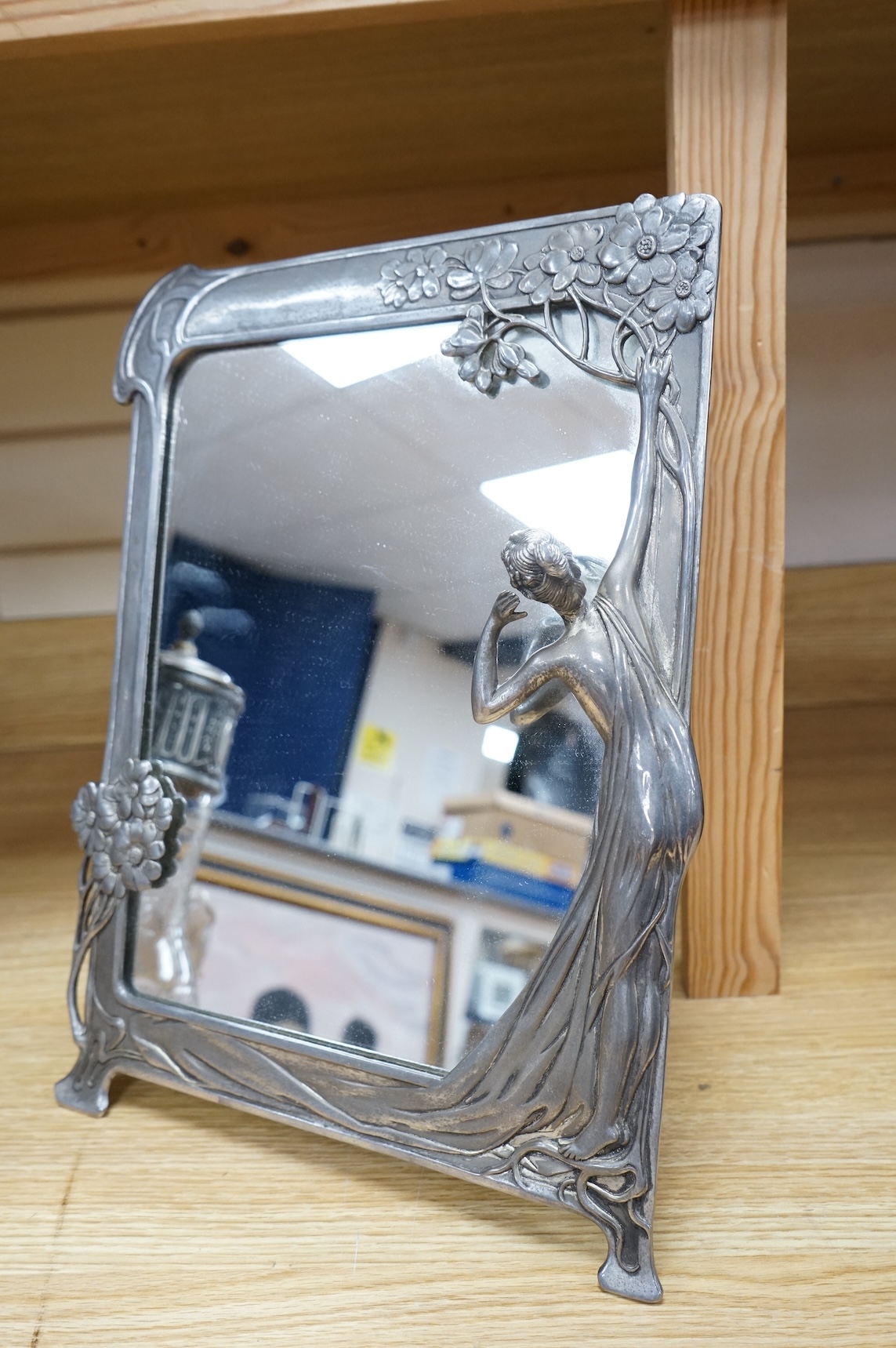 A WMF style metal mounted and engraved glass claret jug and a later figural easel mirror, tallest mirror 36cm.